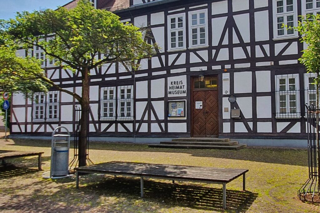 Die weiße Fachwerkfassade des Kreisheimatmuseums in Rotenburg an der Fulda mit dunklen Balken und einem hölzernen Eingangsportal.